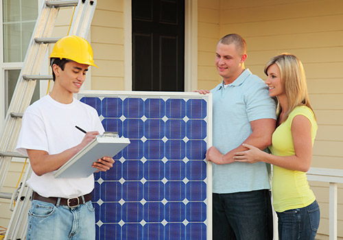 Man in a hard hat putting together a quote for a couple