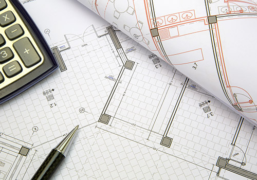 Blueprints with a calculator and pen
